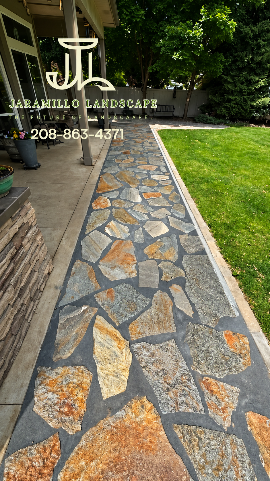 Flagstone pathway leading to patio with lush lawn